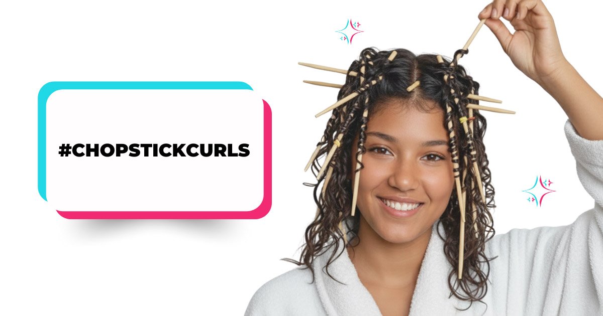 A young woman smiles while using wooden chopsticks to set a 