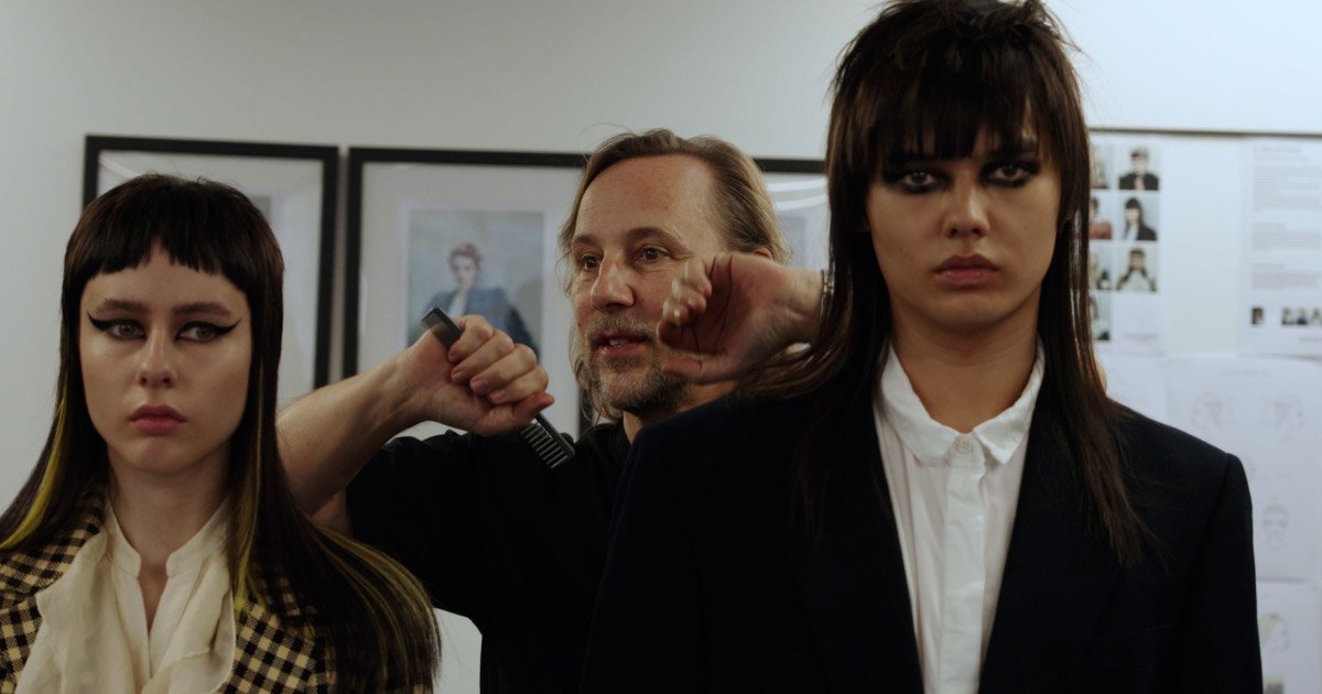 Richard Ashforth with two hair models. Both models have long straight hair with a blunt fringe.