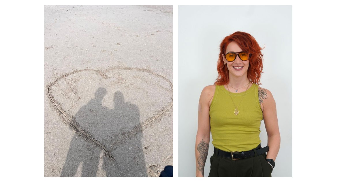 Shadows of two people standing in a heart drawn in the sand next to a woman with red hair and orange sunglasses.