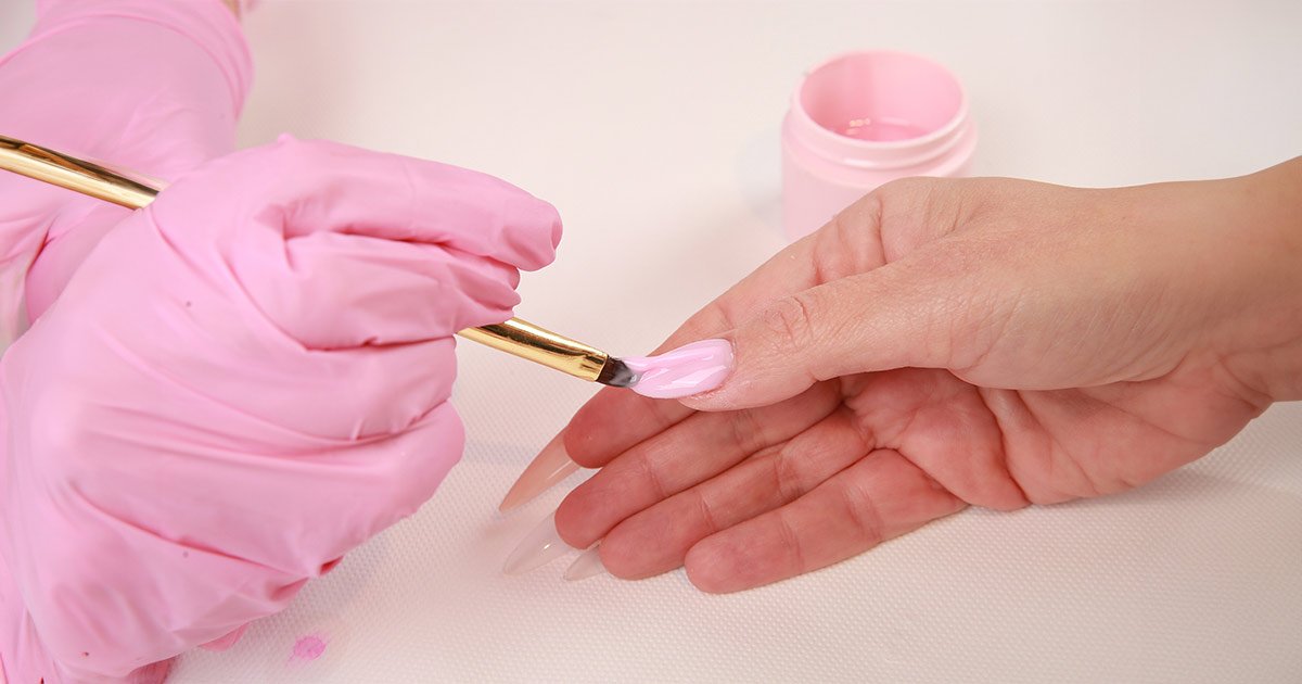 Application of PureSculpt to the nails with a brush