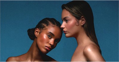 Two female models with hydrated skin post next to one another